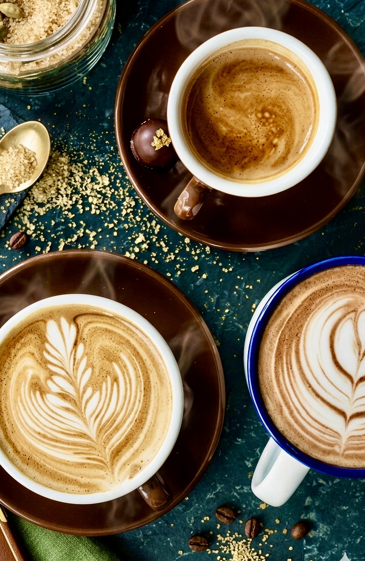 Coffee cups at Lua Cafe, Trim — a flat-lay of lattes and espressos on a dark stone surface